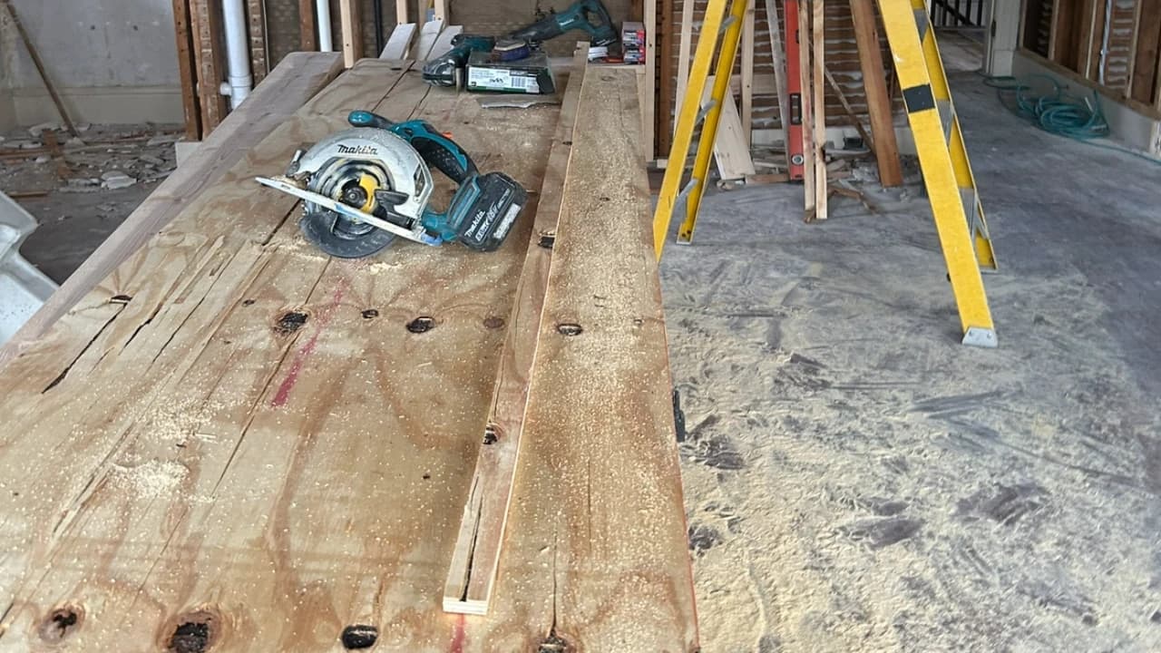 Plywood subfloor and circular saw during a Kovich & Savard hardwood installation
